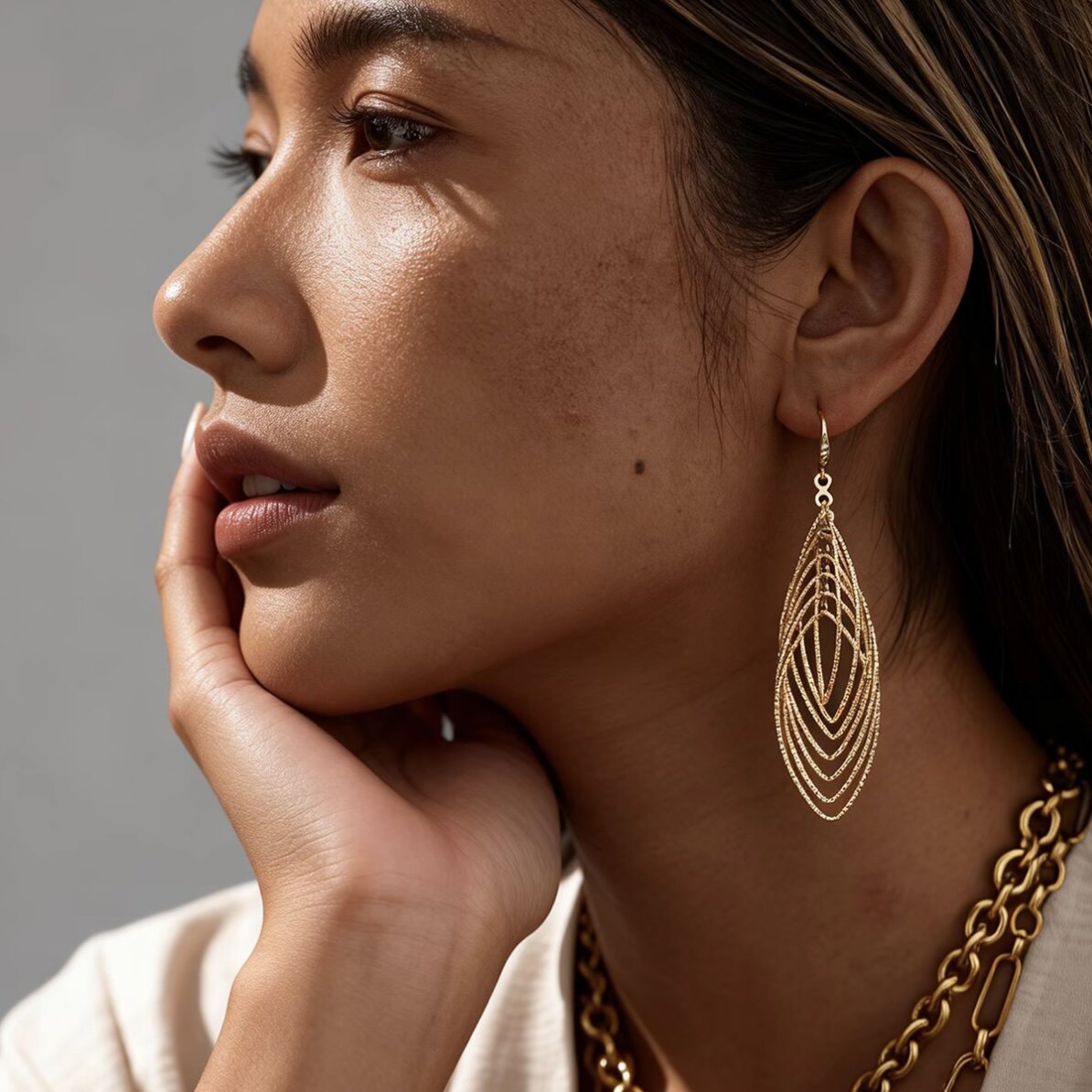 Woman wearing silver teardrop filigree dangle earrings with elegant updo